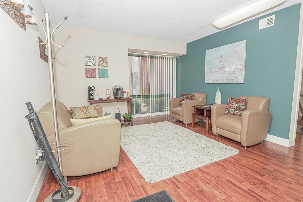 a living room with couches and chairs and a rug