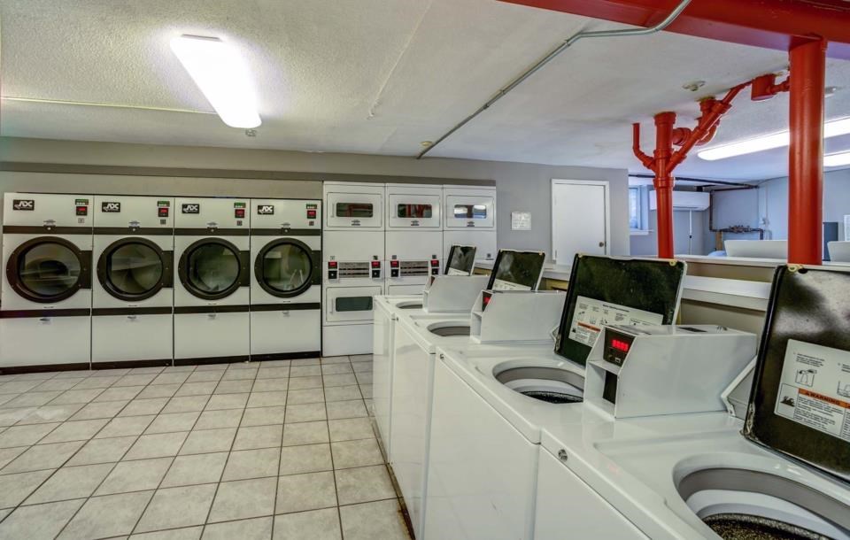 a laundry room filled with lots of washing machines