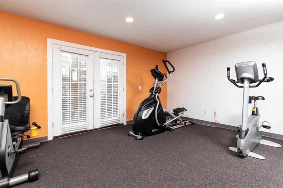 a gym with exercise equipment and a window