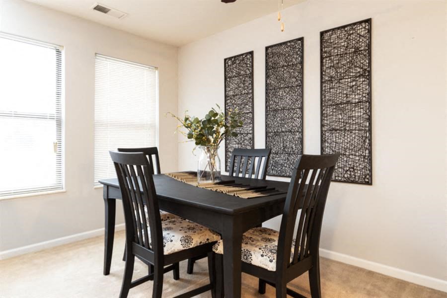 a dining room with a table and chairs
