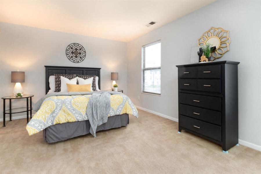 a bedroom with a bed and a dresser