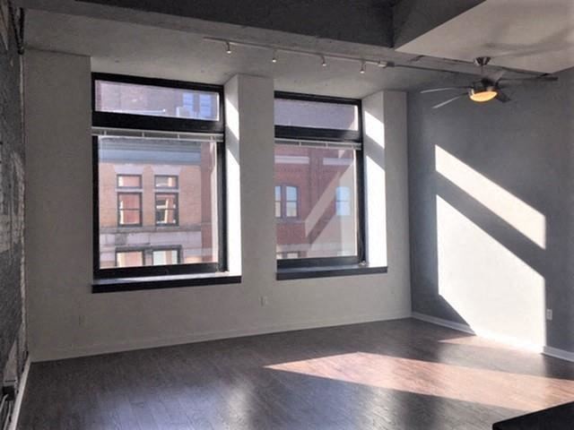 an empty room with three windows in it