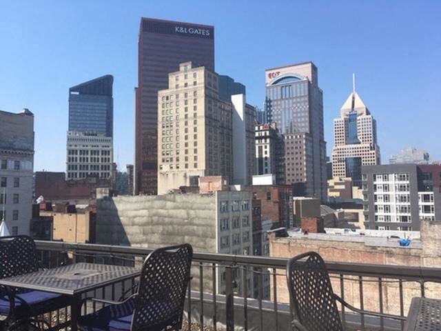 a view of the city skyline from a patio with chairs