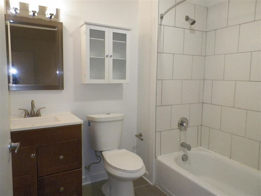 a bathroom with a toilet and a sink and a tub