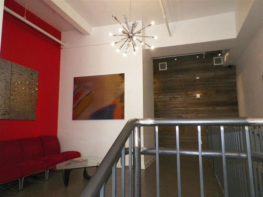 a living room with a staircase and a chandelier