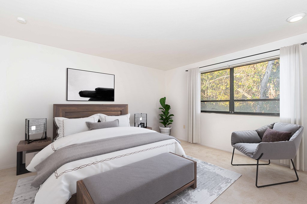 a bedroom with a bed and a large window