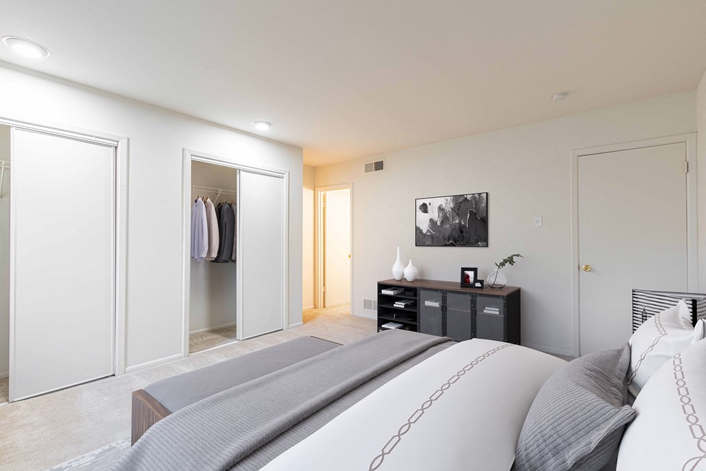 a bedroom with a large bed and a closet