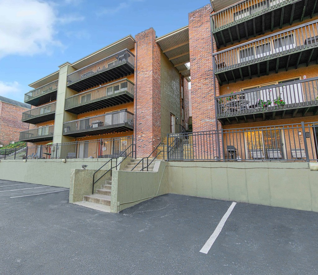 an exterior view of an apartment building with stairs and balconies