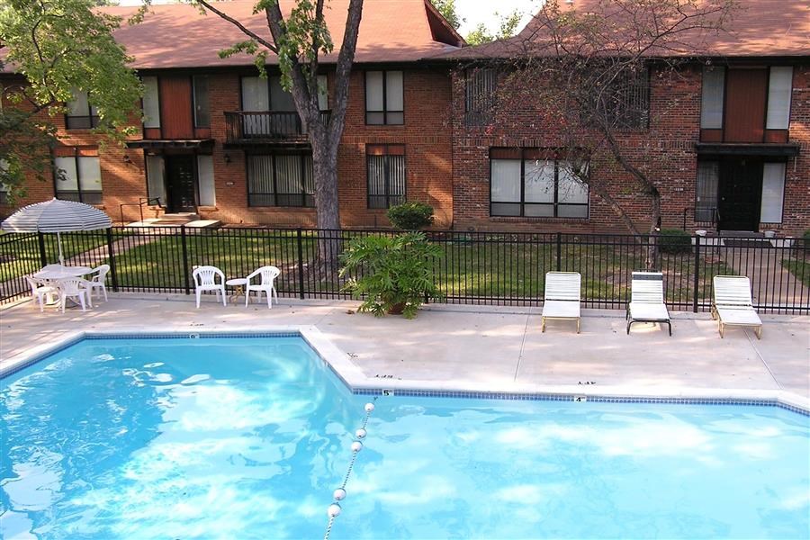 a swimming pool in front of an apartment building