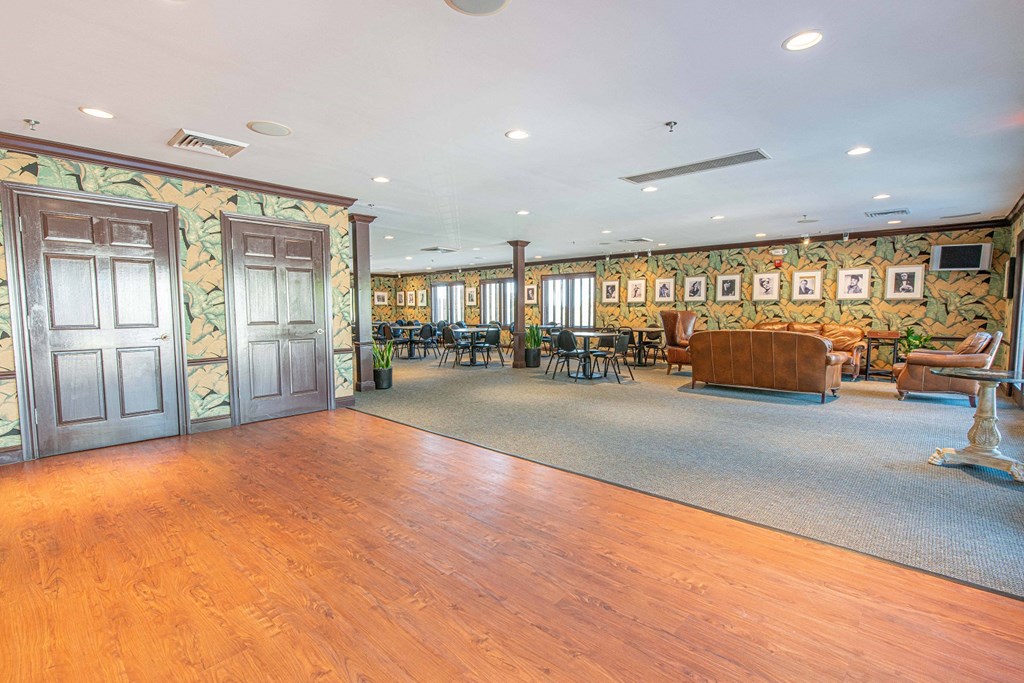 a large living room with wood floors and a blue door