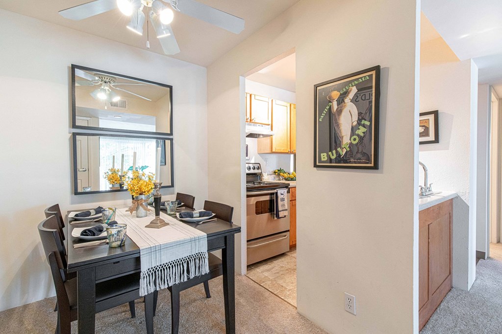 a dining room and kitchen with a table and chairs