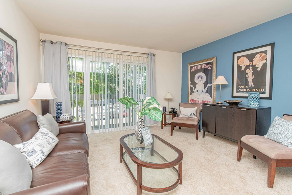 a living room with a couch and a glass table