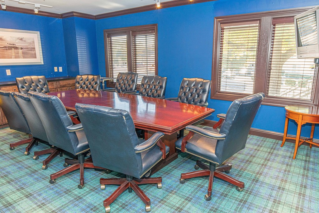 a conference room with a wooden table and chairs