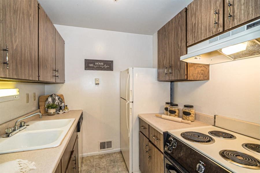 a kitchen with a stove sink and refrigerator