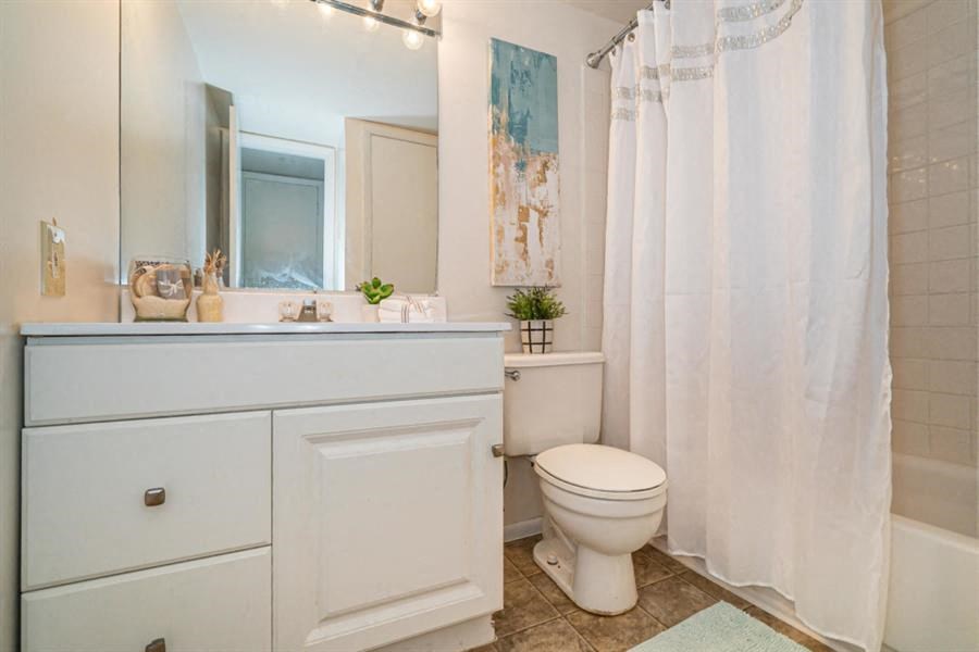 a bathroom with a shower curtain and a toilet and a sink