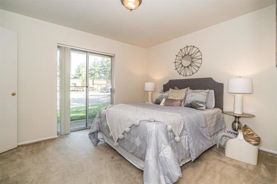 a bedroom with a bed and a sliding glass door