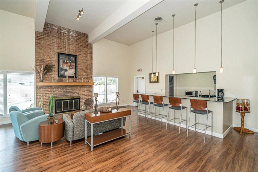 a living room with a bar and a fireplace
