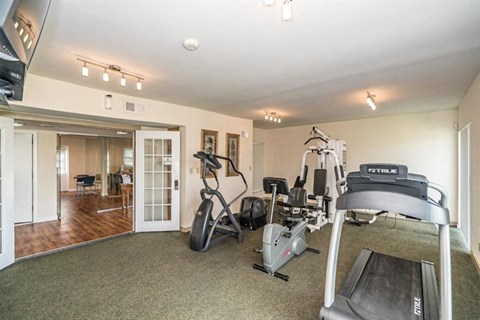 a gym with exercise equipment in a room