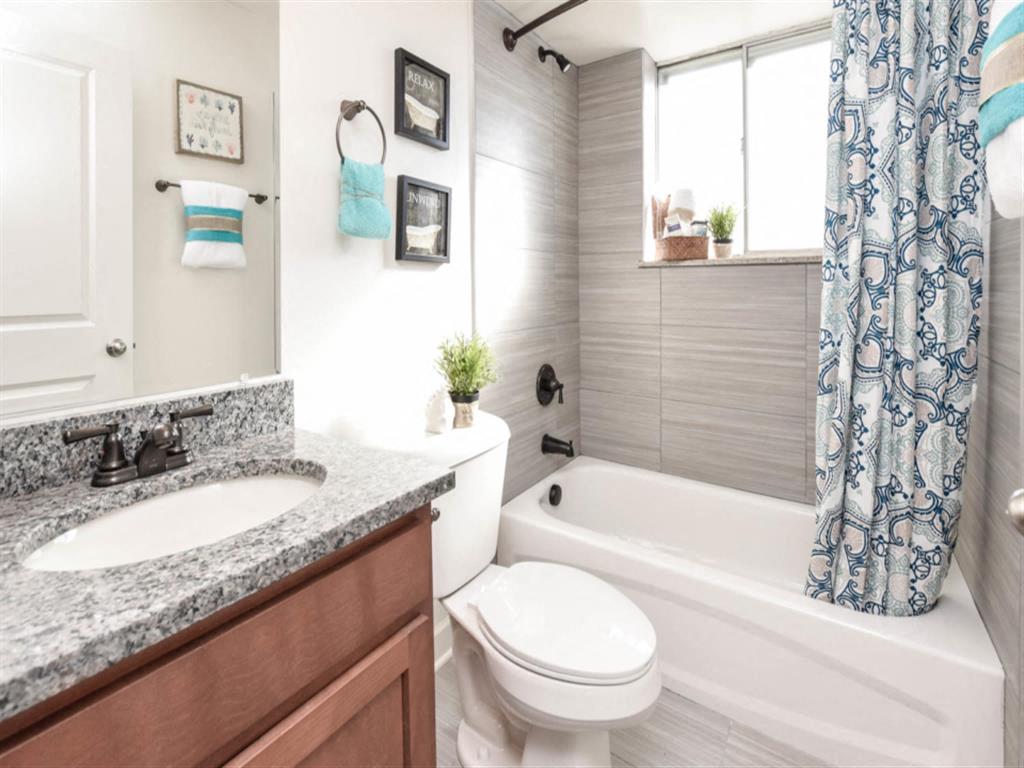 a bathroom with a sink toilet and a tub