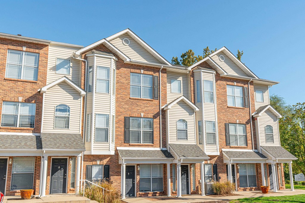 a row of town houses with brick and white siding