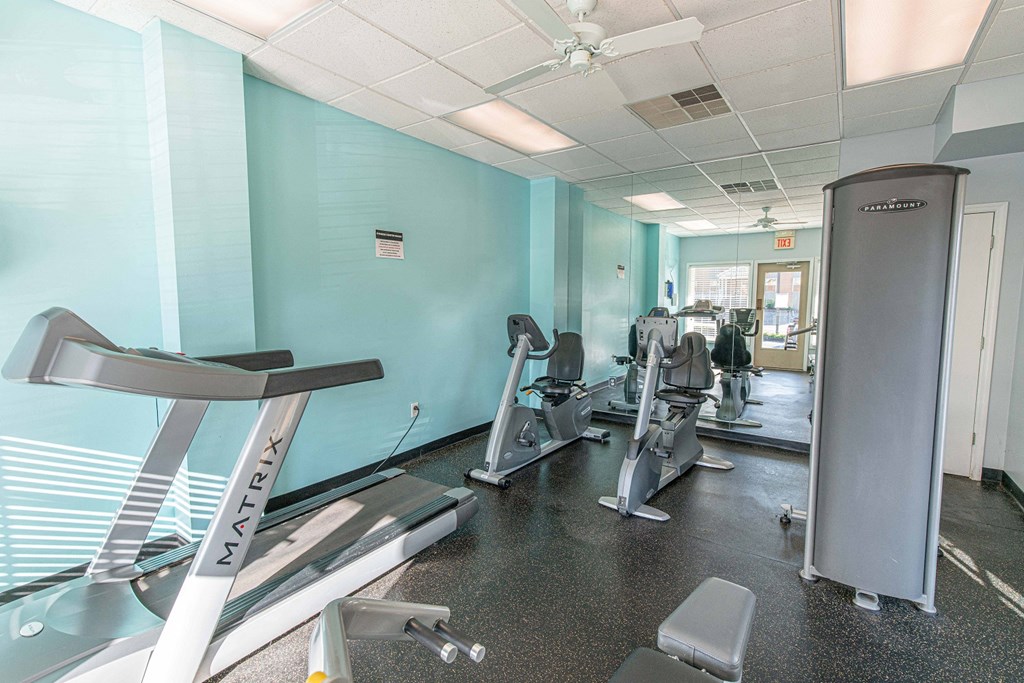 a gym with treadmills and other exercise equipment in a building