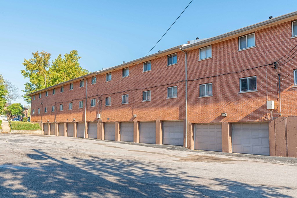 a large brick building with garage doors on a street