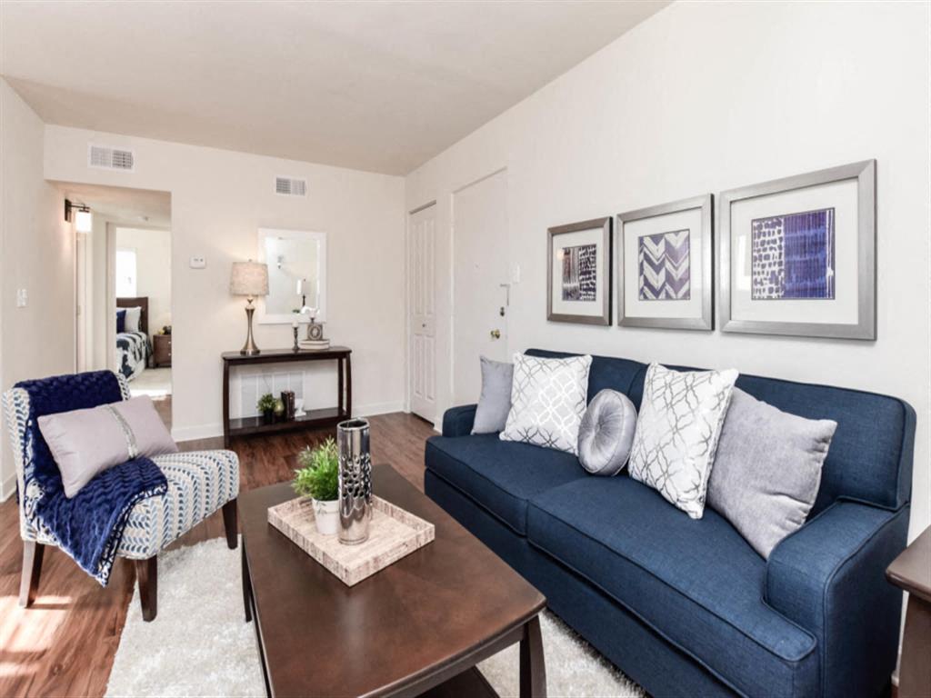 a living room with a blue couch and a coffee table