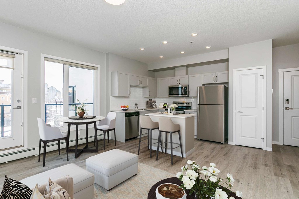 an open kitchen and living room with a table and chairs