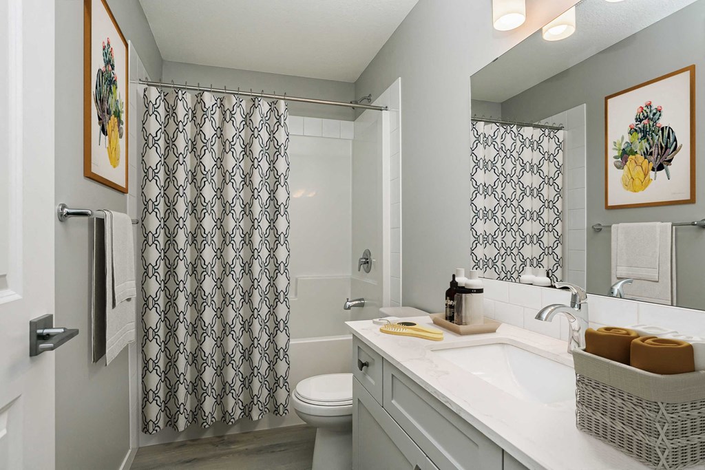 a bathroom with a sink and a toilet and a shower