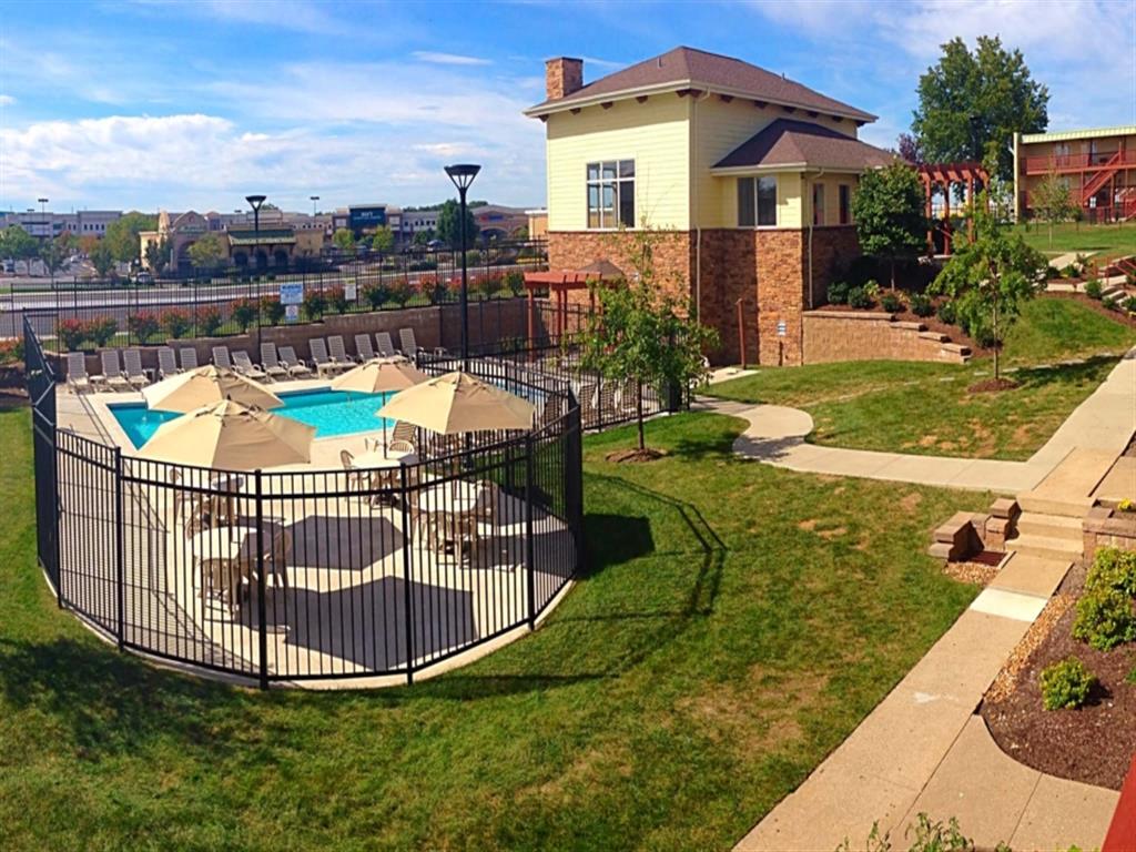 a backyard with a pool and a house with a fence