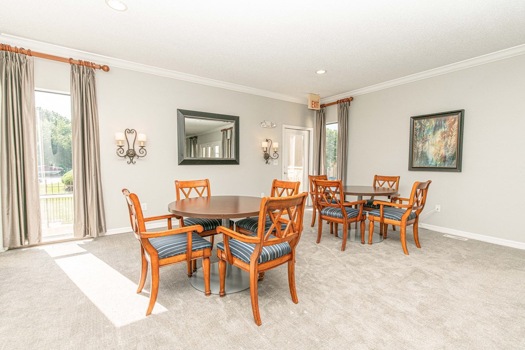 a dining room with a table and chairs
