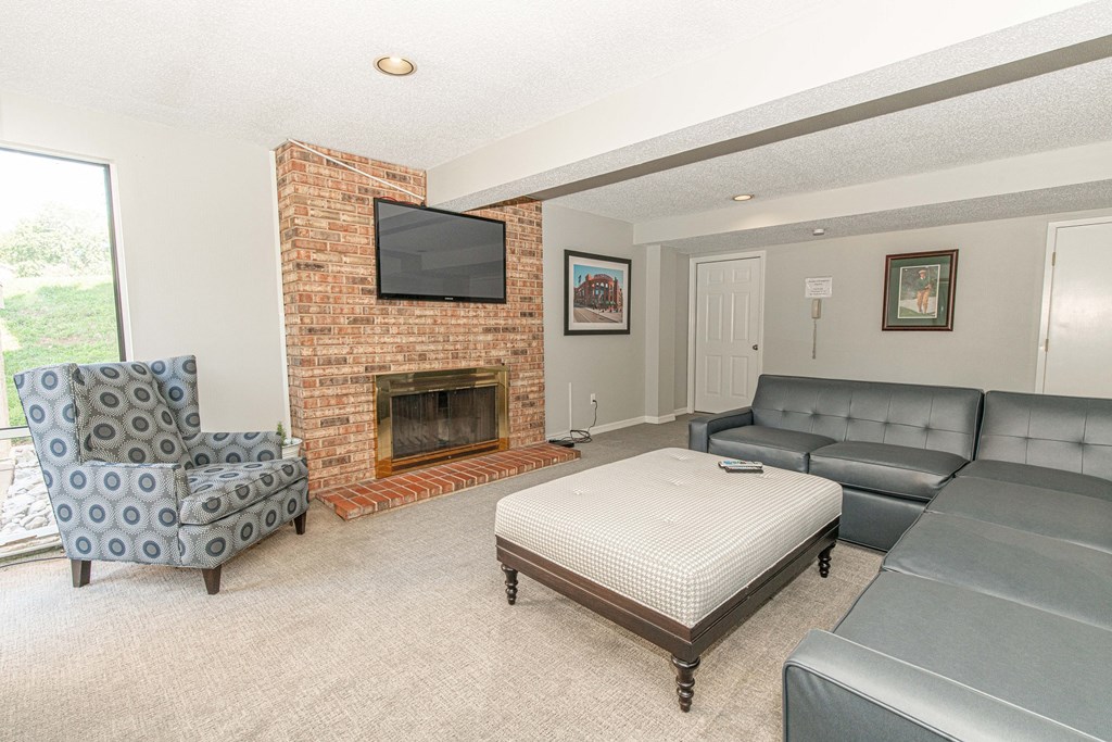 the living room has a fireplace and leather couches