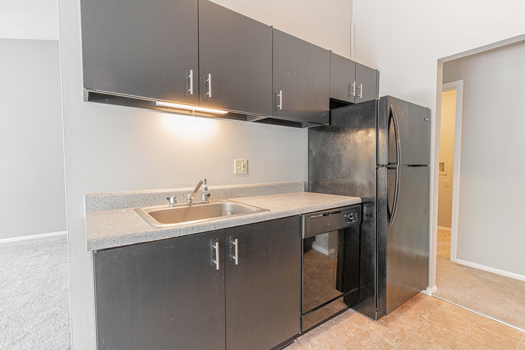 a kitchen with stainless steel appliances and a stainless steel refrigerator