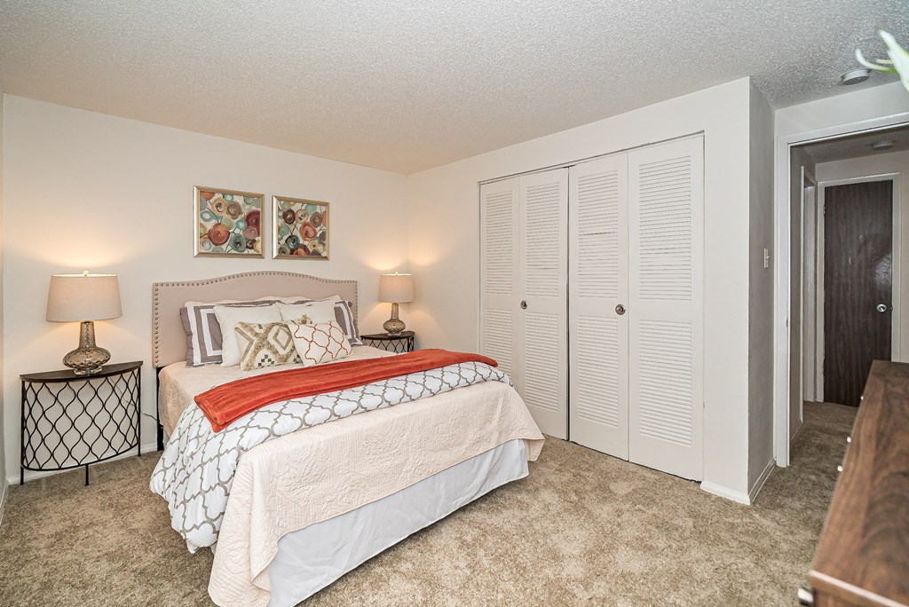 a bedroom with a bed and a closet