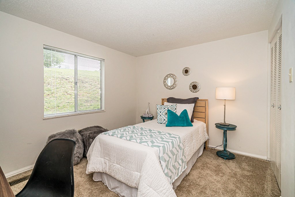 a bedroom with a bed and a window