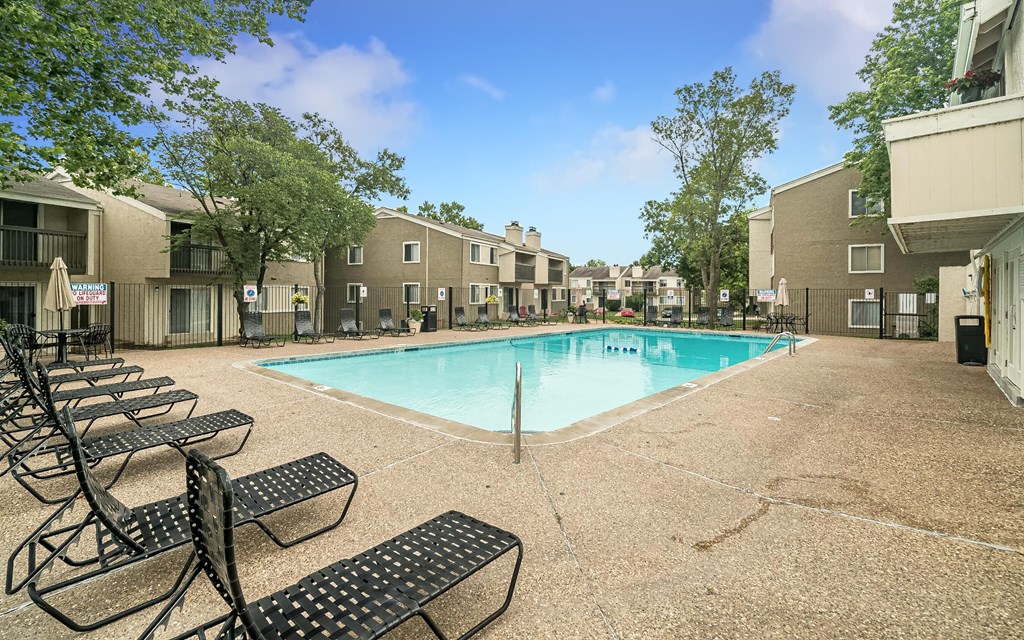 our apartments offer a swimming pool with seating and tables