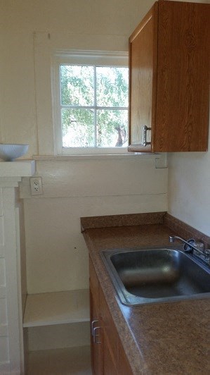 a small kitchen with a sink and a window