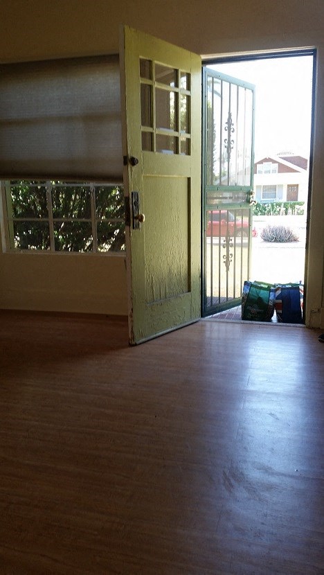 an empty living room with an open door