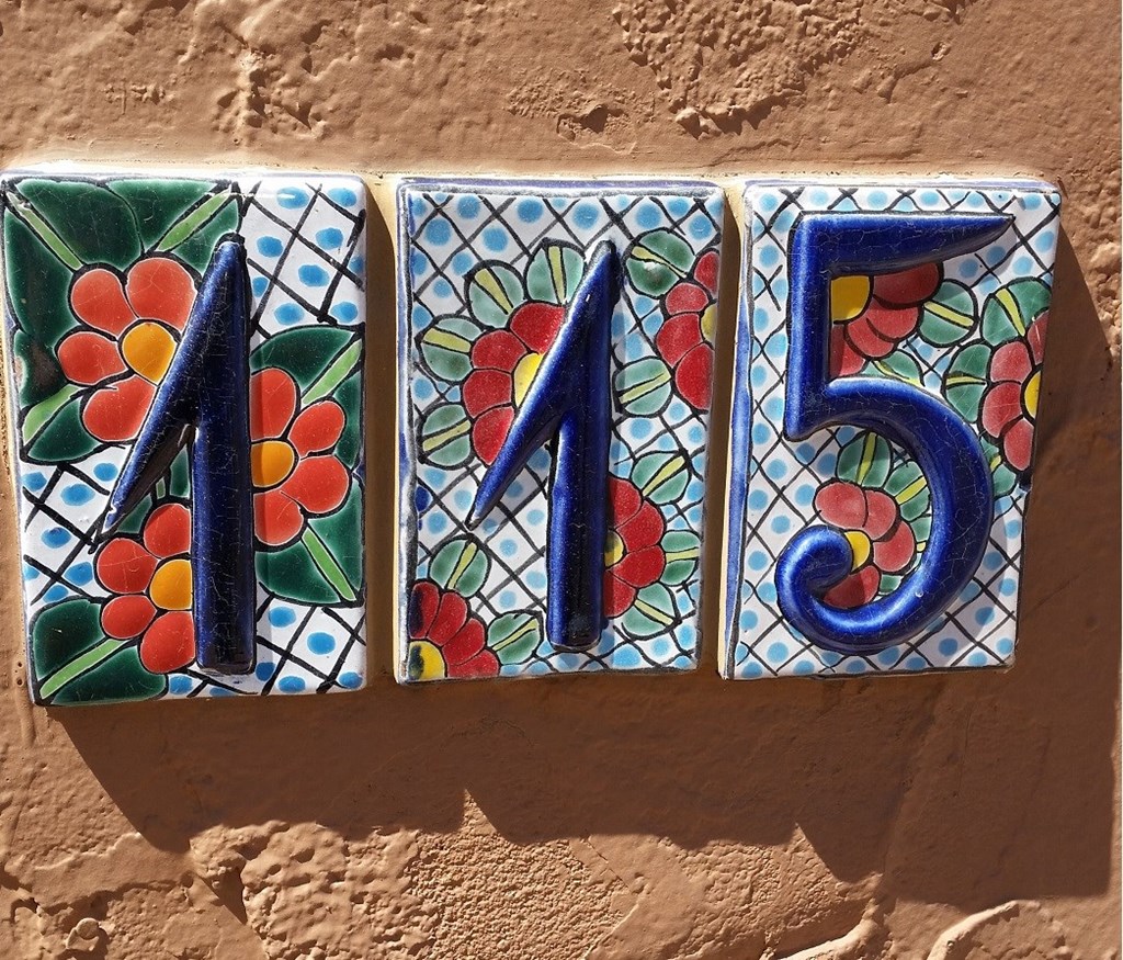 a set of 4 tiles with numbers on a wall