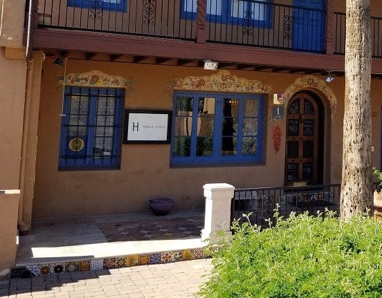 a building with blue windows and a sign on it