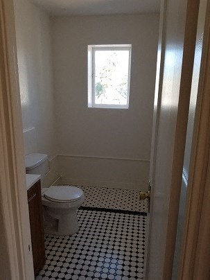 a small bathroom with a toilet and a window