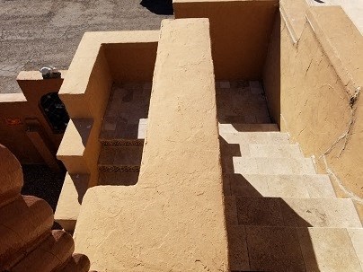 a set of steps in a building with shadows on the ground