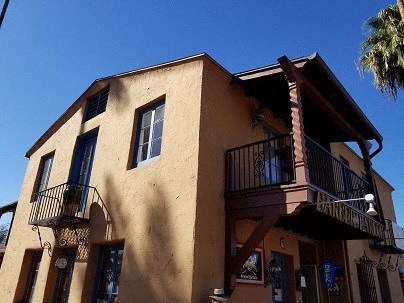 a building with two balconies and a tree