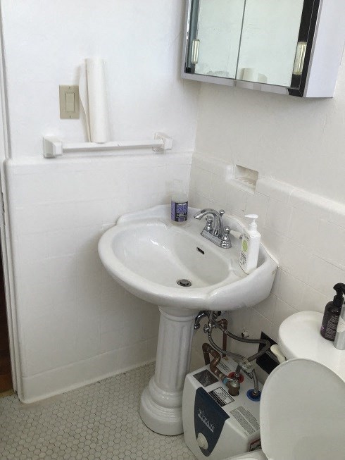 a bathroom with a sink and a toilet and a mirror