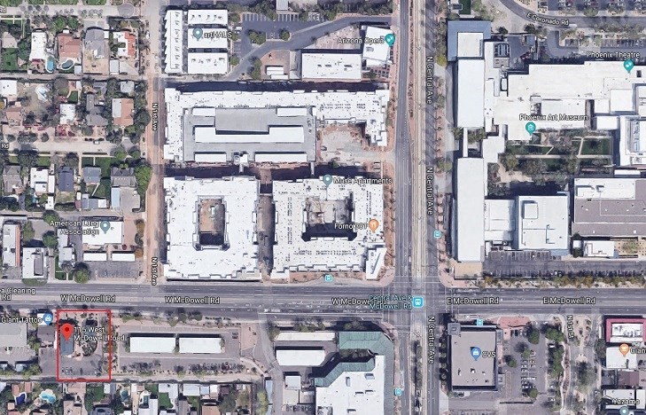 an aerial view of a city with a road and buildings