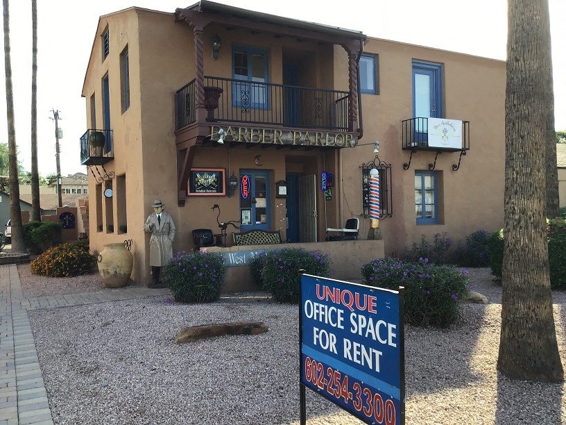 an office space for rent sign in front of a building