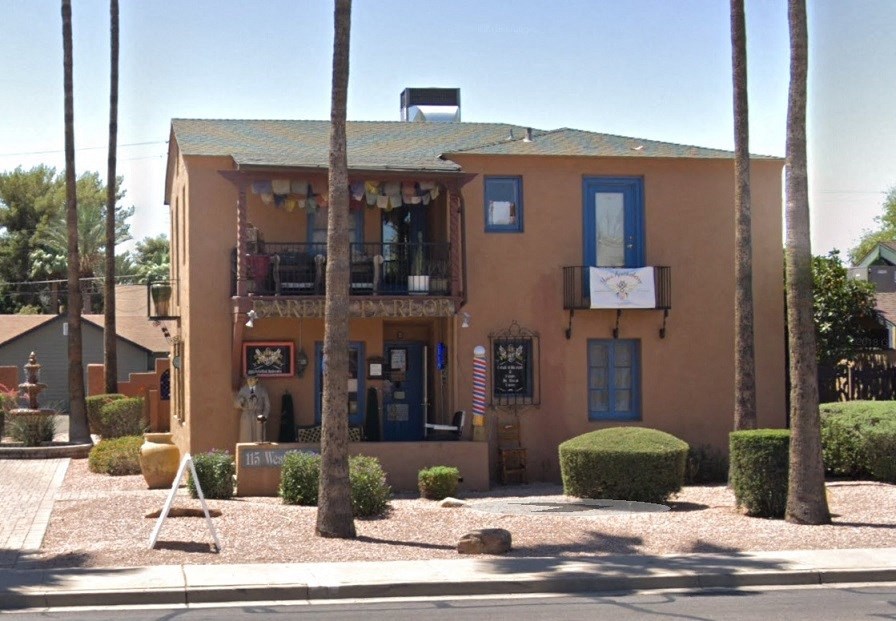 a building with a balcony and a sign on the front of it