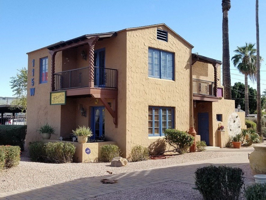 a building with two balconies and a street in front of it