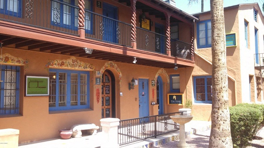 a building with a balcony and a blue door