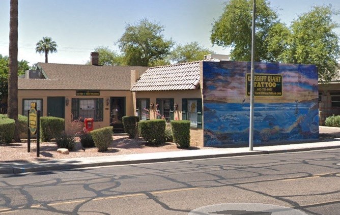 a building with a mural on the side of a street